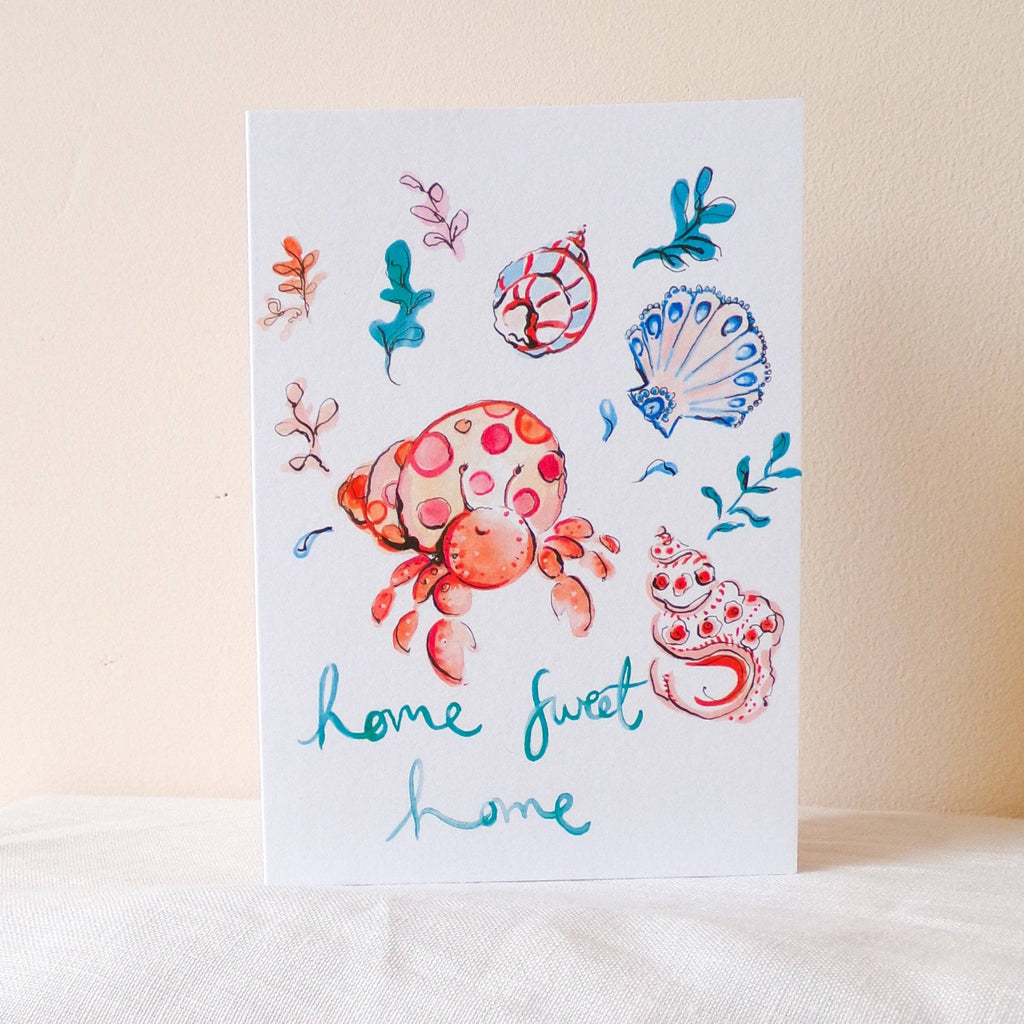 Card with a colorful crab and shell design on a light background