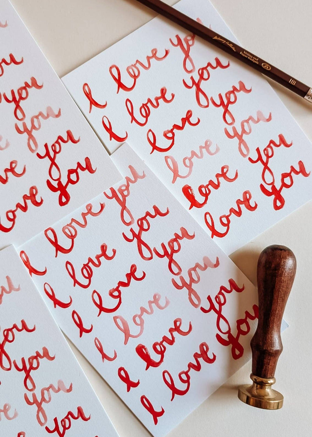 Sheet of 'I love you' stickers with a stamp on a light background