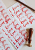 Sheet of 'I love you' stickers with a stamp on a light background