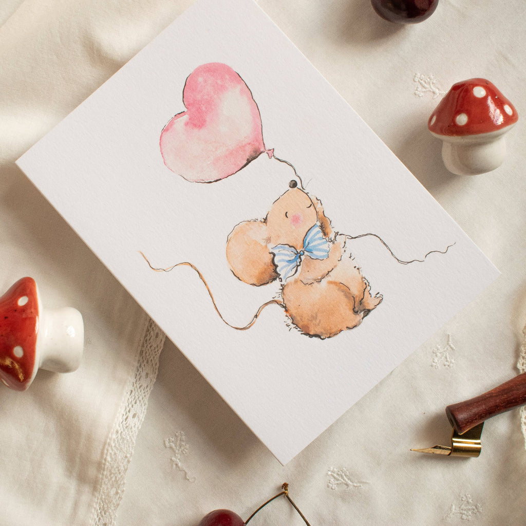 Card with teddy bear and heart balloon illustration on a textured surface with mushrooms and cherries.