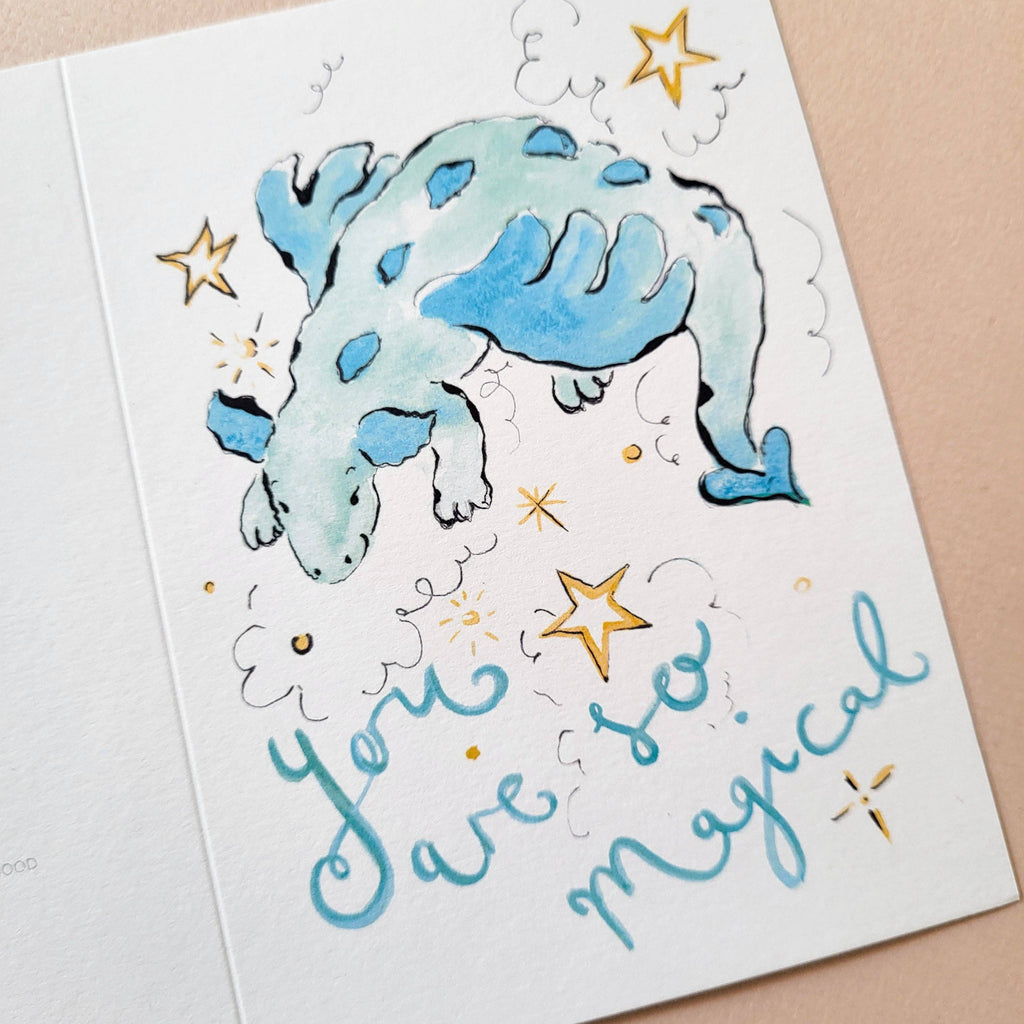 Card with a blue dinosaur illustration and 'You are so magical' text on a beige background