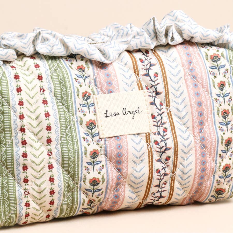 Patterned fabric roll with 'Lisa Angel' label on a beige background