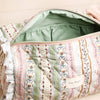 Patterned fabric inside a bag with visible brand name.