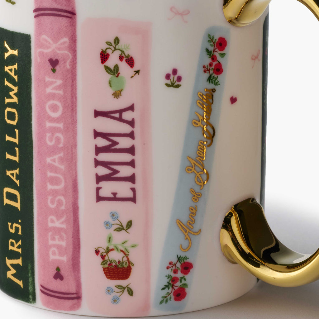 Mug with book-themed design featuring names and decorative elements on a white background.