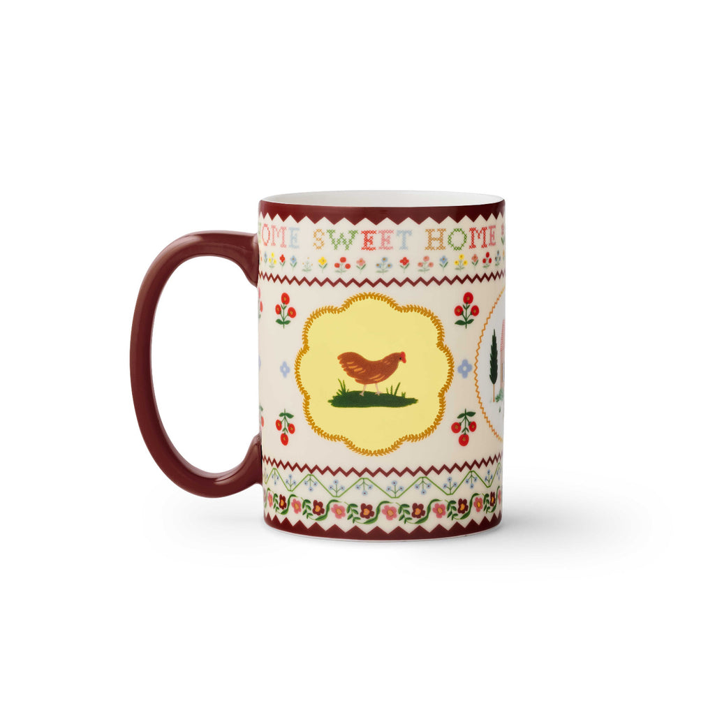 Decorative mug with a chicken illustration and 'Home Sweet Home' text on a white background