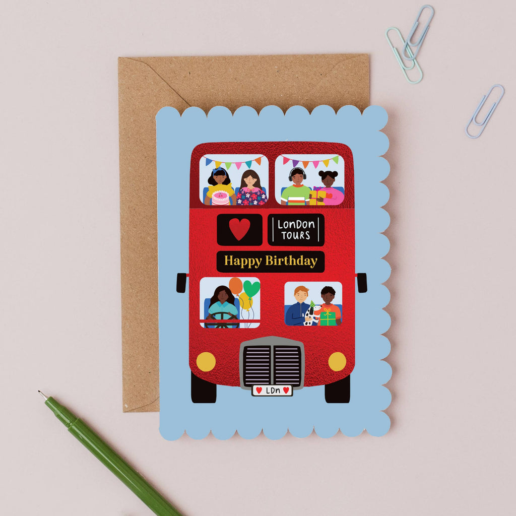 Birthday card with a red London bus design on a light brown background