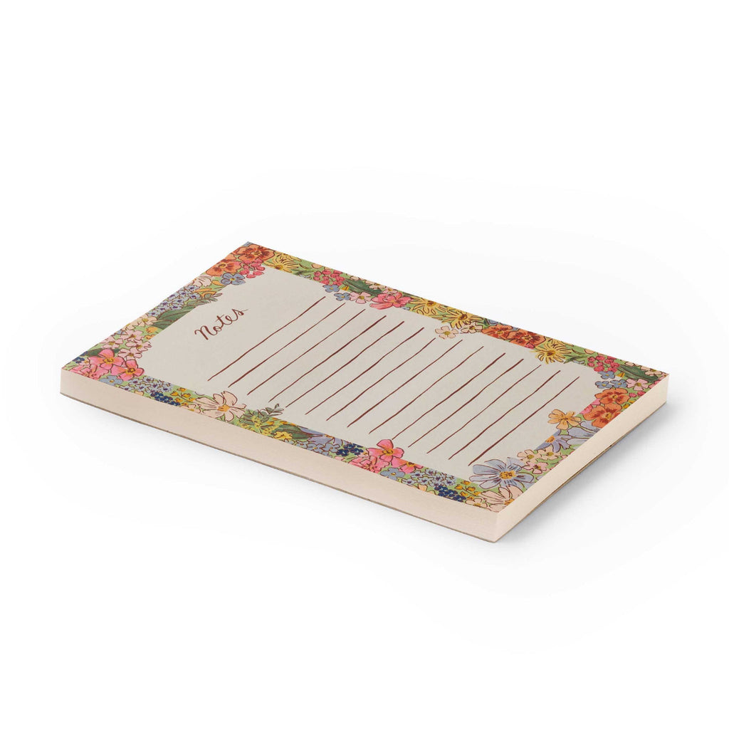 Floral border notepad with lined paper on a white background