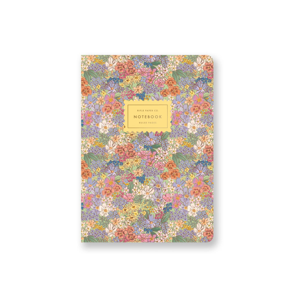 Floral patterned notebook with a gold label on a white background