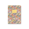 Floral patterned notebook with a gold label on a white background