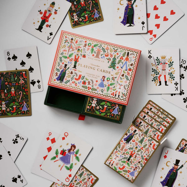 Set of playing cards with decorative box on a white background