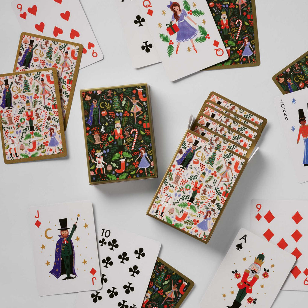 Set of playing cards with festive designs on a white background