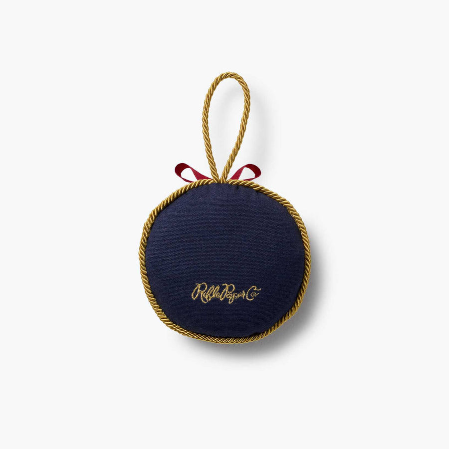 Round navy blue pouch with gold trim and 'Ruthie May' branding on a white background