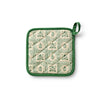 Quilted pot holder with green floral pattern on a white background