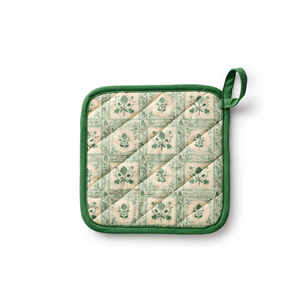 Quilted pot holder with green floral pattern on a white background