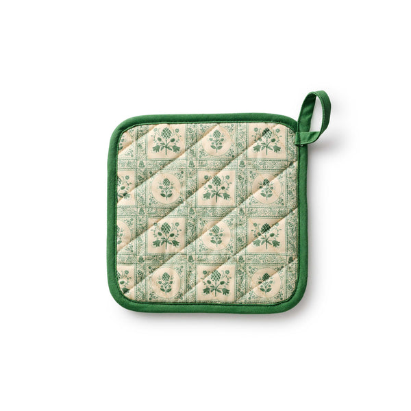 Quilted pot holder with green floral pattern on a white background