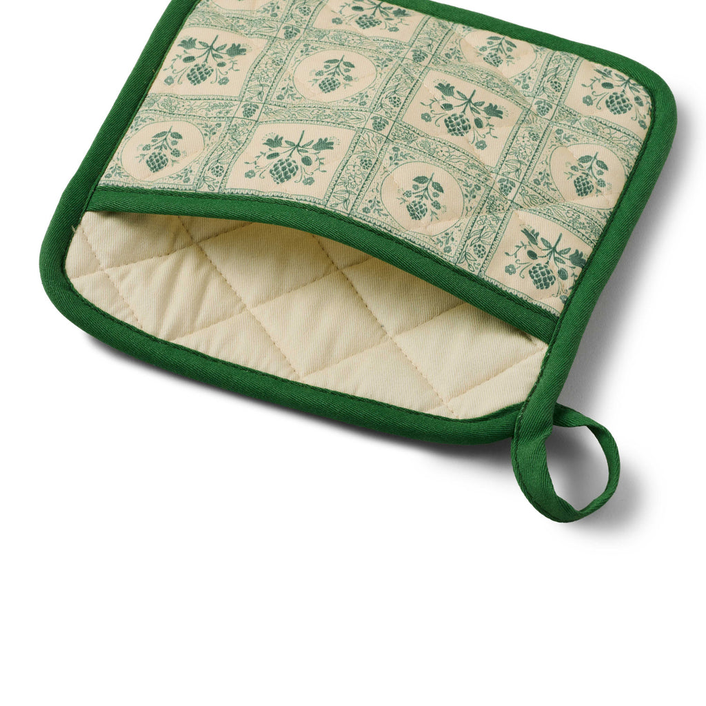 Green and beige quilted pot holder with pattern on a white background