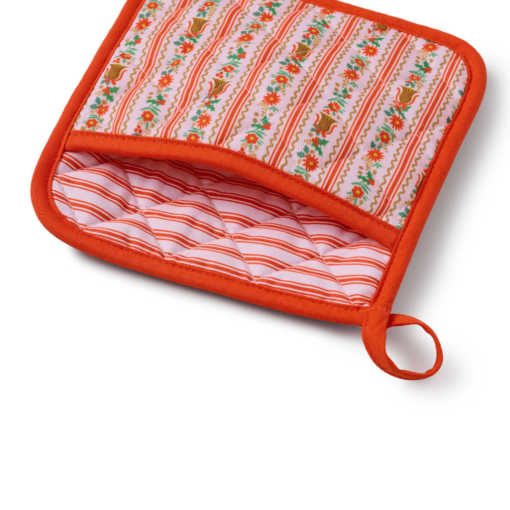 Fabric pot holder with floral pattern on a white background