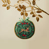 Decorative Christmas ornament with reindeer design on a beige background