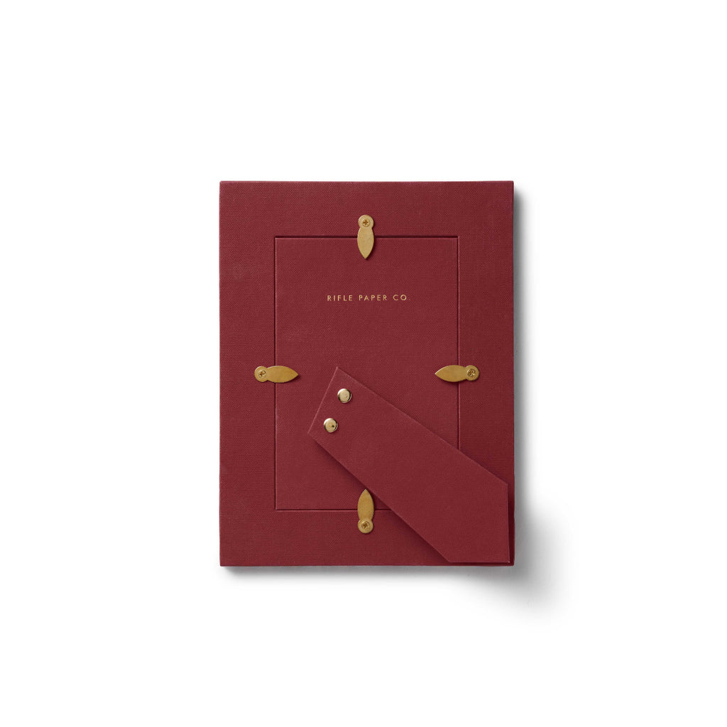 Red card with gold accents and 'Rifle Paper Co.' branding on a white background
