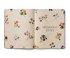 Floral-patterned notebook with 'Important Dates' text on a beige background