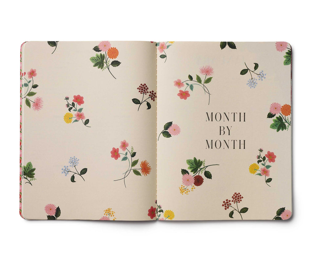 Floral notebook with 'Month by Month' text on a beige background