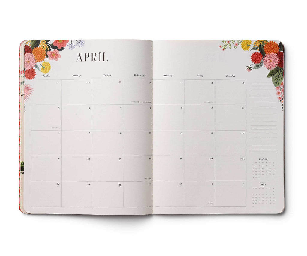 Open planner showing April with floral design on the cover and edges