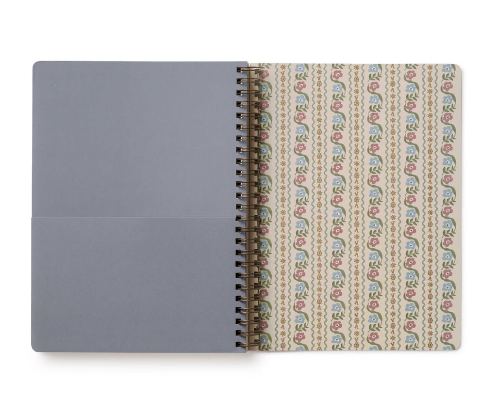 Notebook with a patterned cover and plain gray back on a white background