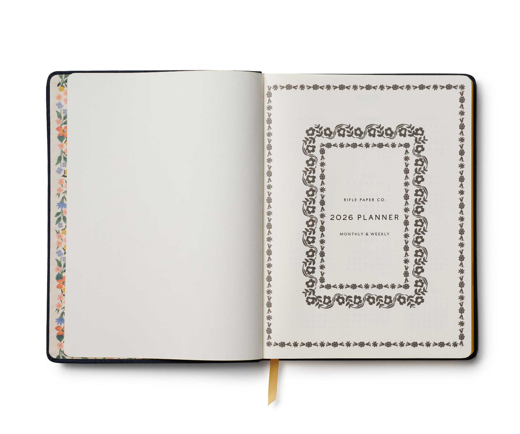 Open planner with decorative cover and floral border on a white background