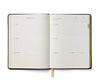 Open planner with daily schedule on a white background