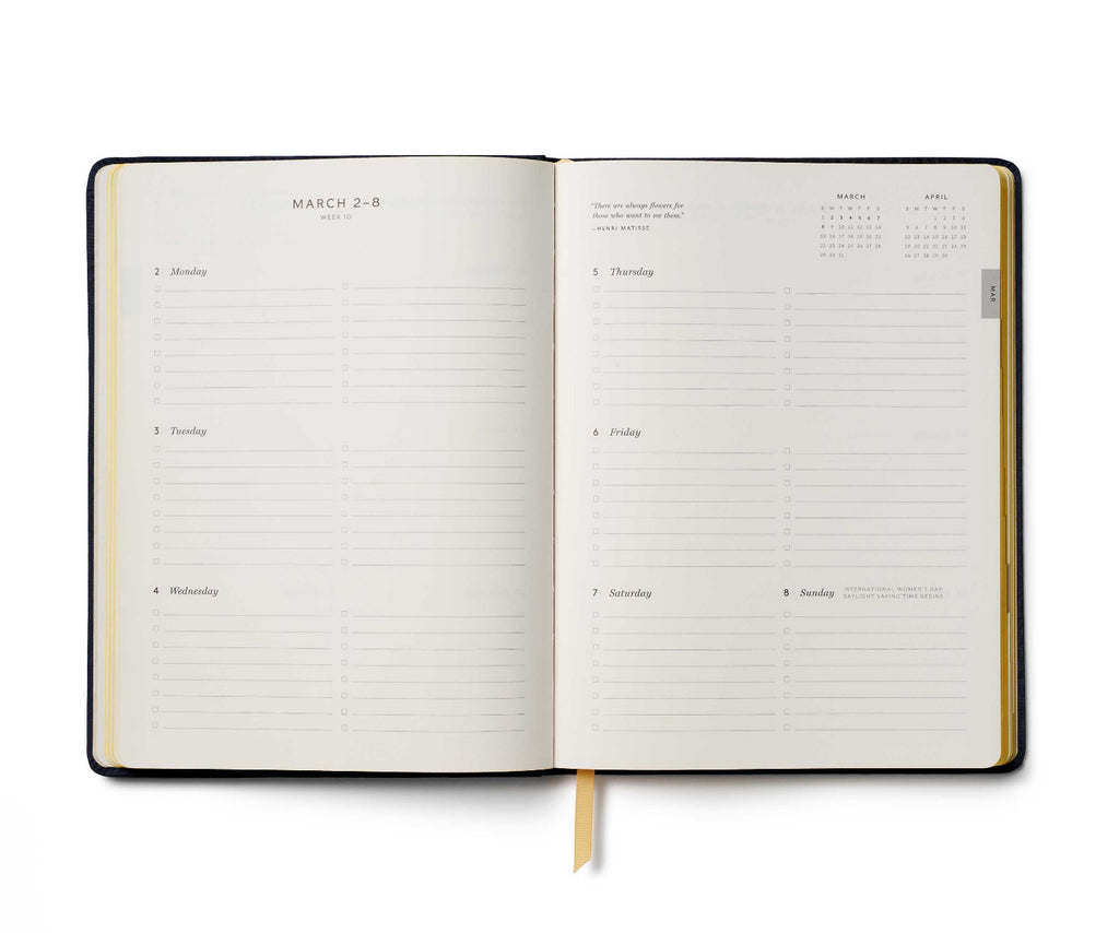 Open planner with daily schedule on a white background
