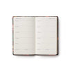 Open planner with floral design on a white background