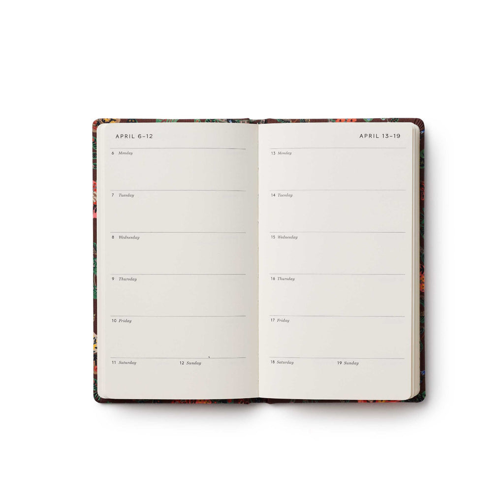 Open planner with floral design on a white background