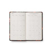 Open planner with floral design on a white background