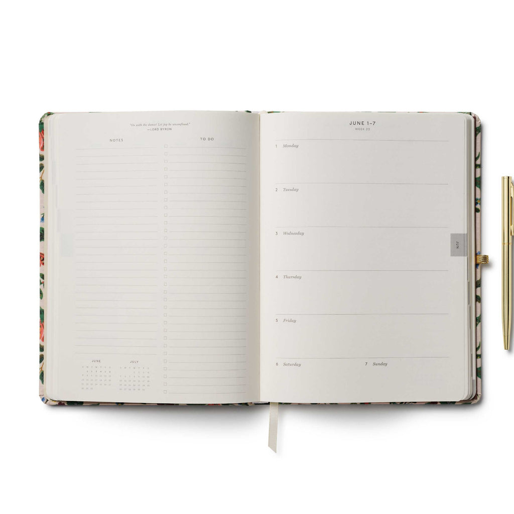 Open planner with floral design on a white background