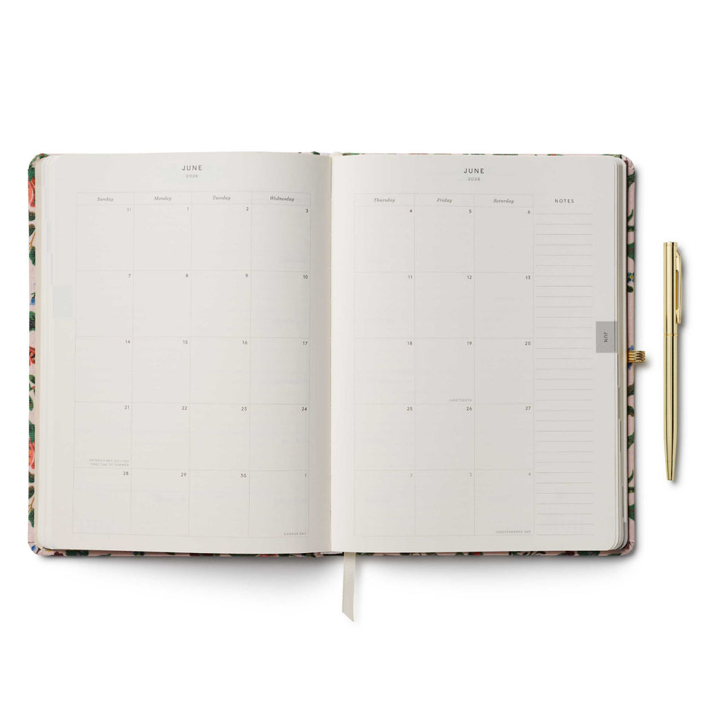 Open planner with floral design on a white background