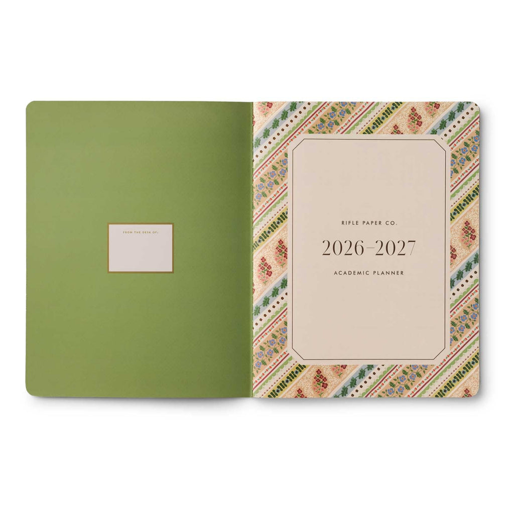 Green planner with a decorative cover featuring 'Rifle Paper Co' branding on a white background.