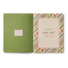 Green planner with a decorative cover featuring 'Rifle Paper Co' branding on a white background.