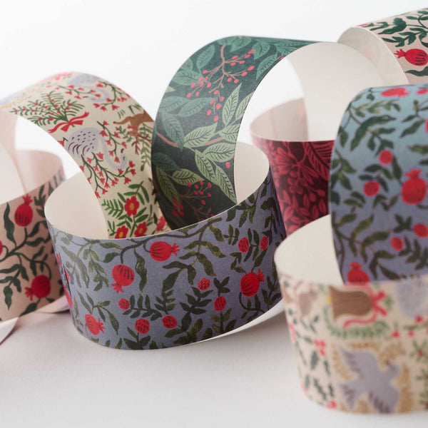 Decorative paper cups with floral patterns on a white surface
