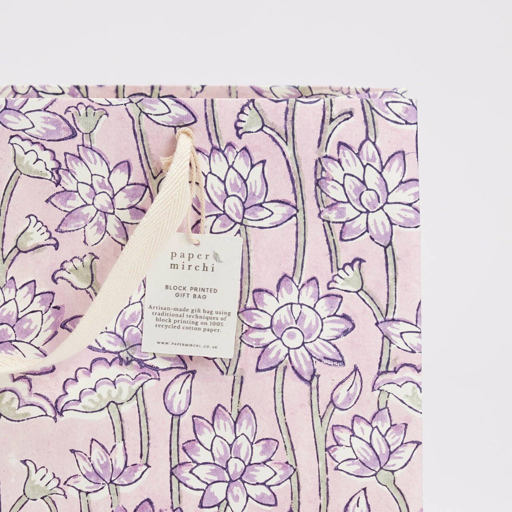 Product packaging with floral design and 'paper mirchi' label on a pink background