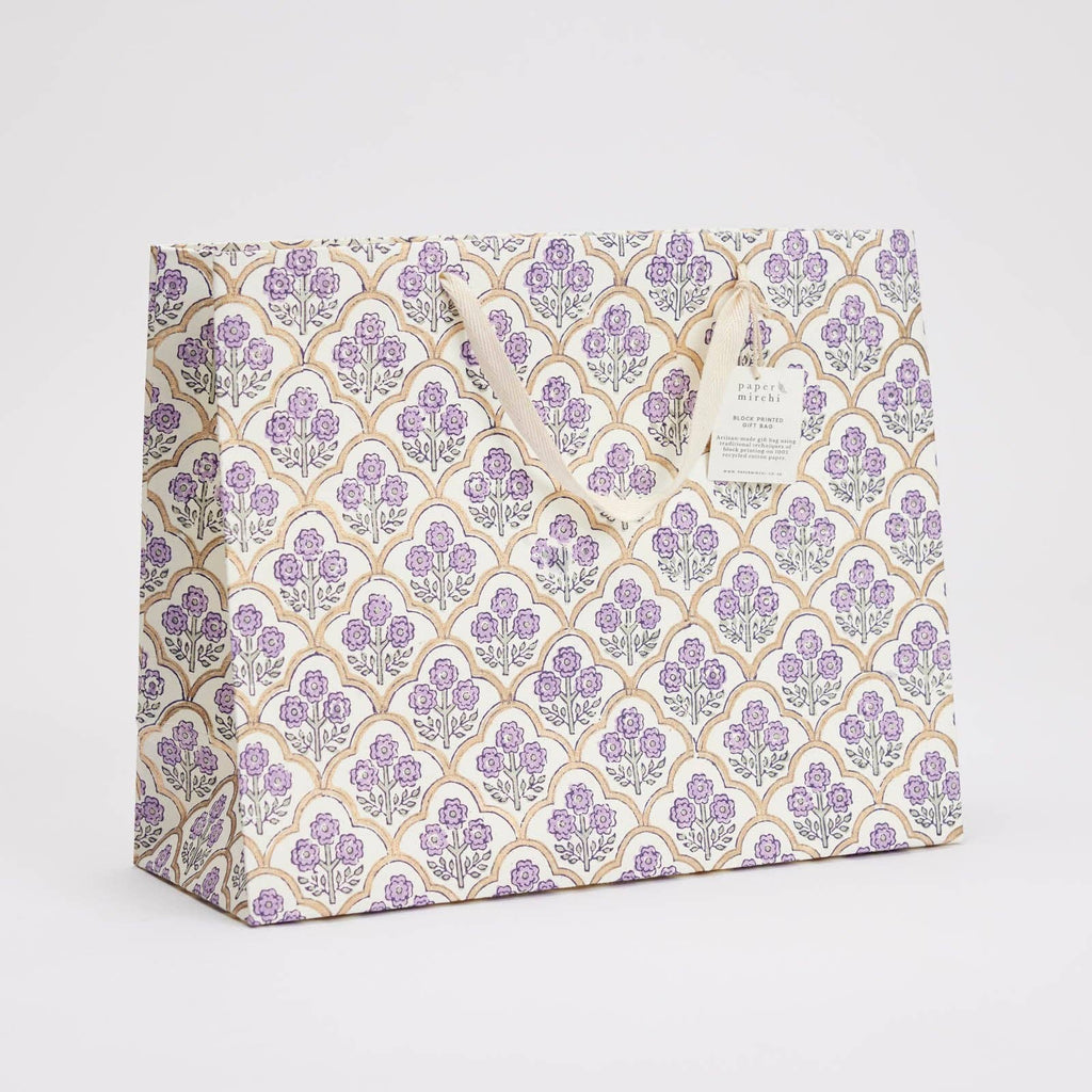 Gift bag with purple floral pattern on a light gray background