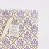 Gift bag with floral pattern and 'paper mirchi' tag on a light gray background