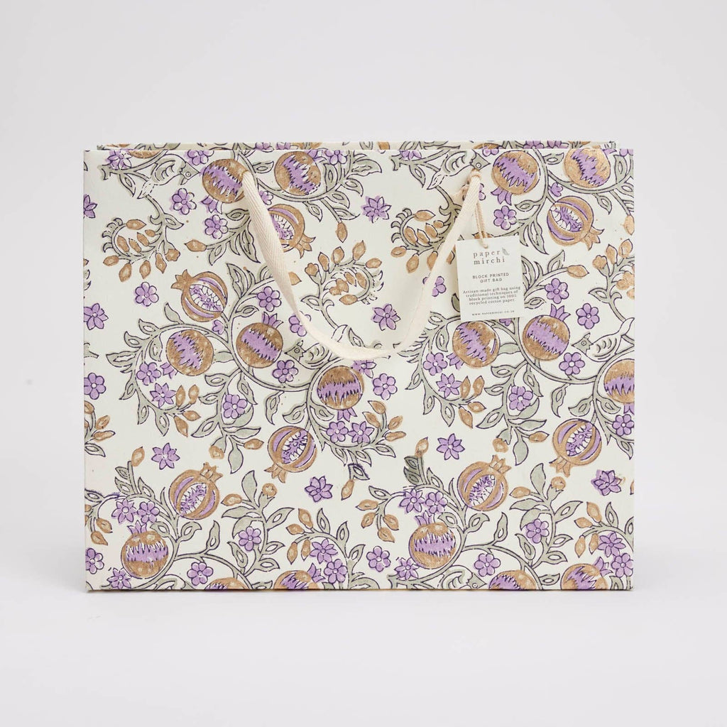 Floral-patterned bag with a visible brand tag on a light gray background