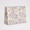 Floral patterned gift bag on a white background