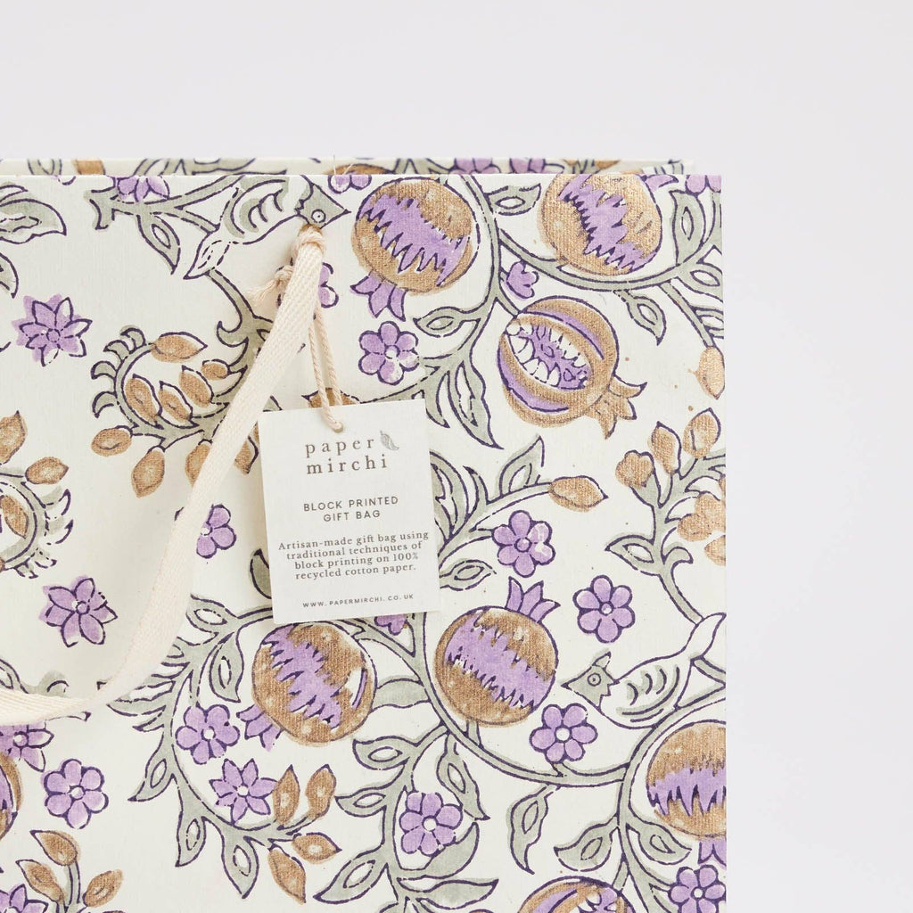 Gift bag with floral and fruit pattern on a white background