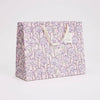 Floral-patterned gift bag on a light gray background