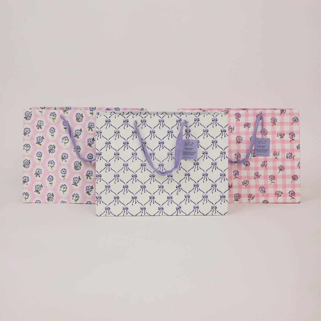 Floral and checkered patterned bag on a light gray background