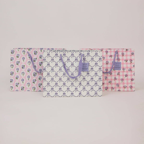 Floral and checkered patterned bag on a light gray background