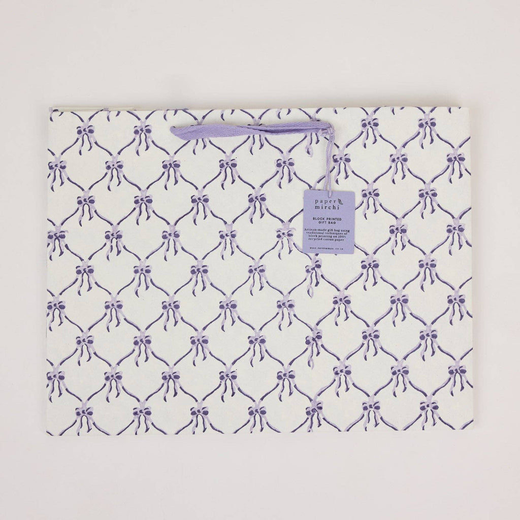 Patterned bag with purple bows on a white background