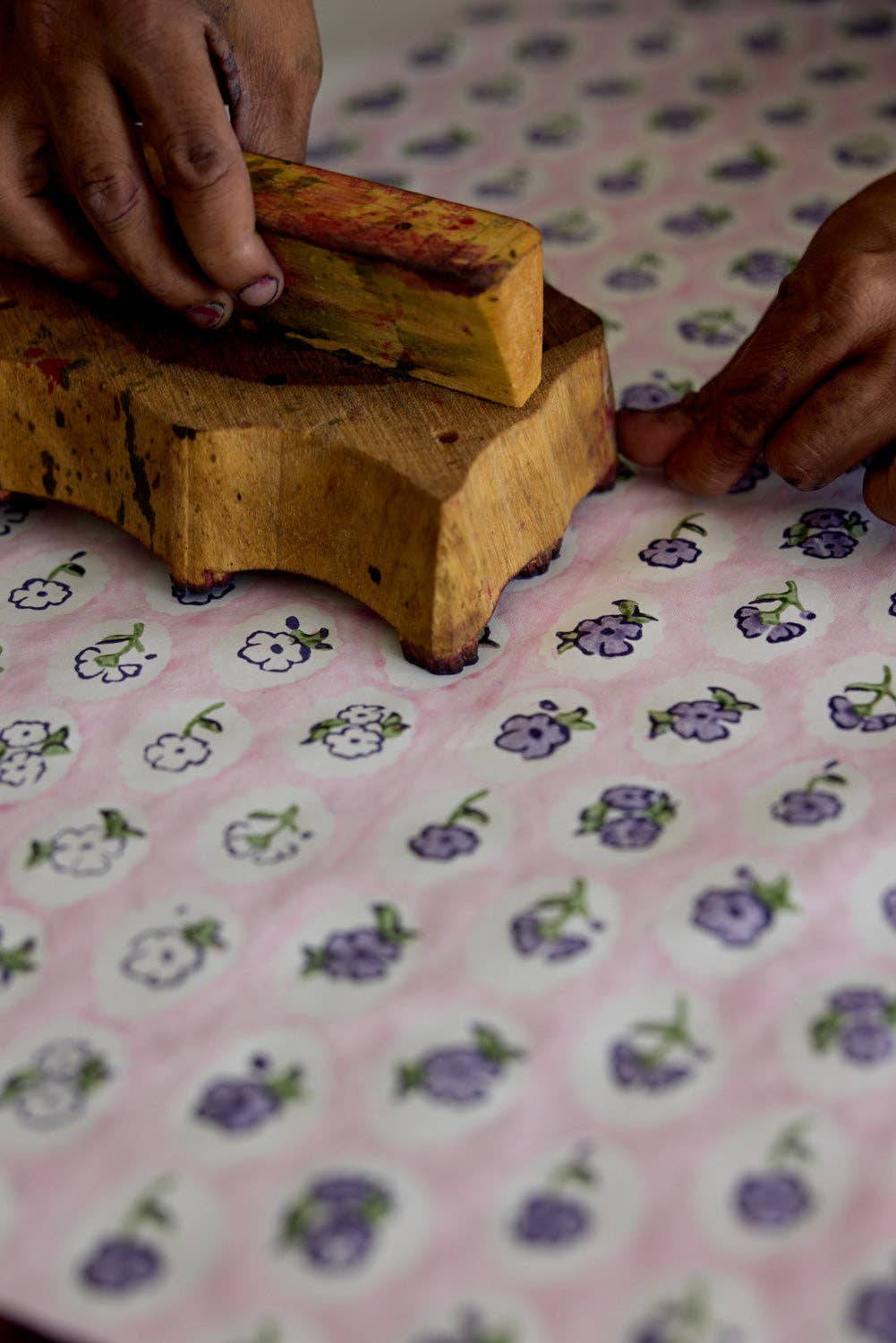 Wooden stamp on a floral-patterned fabric