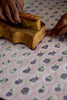 Wooden stamp on a floral-patterned fabric